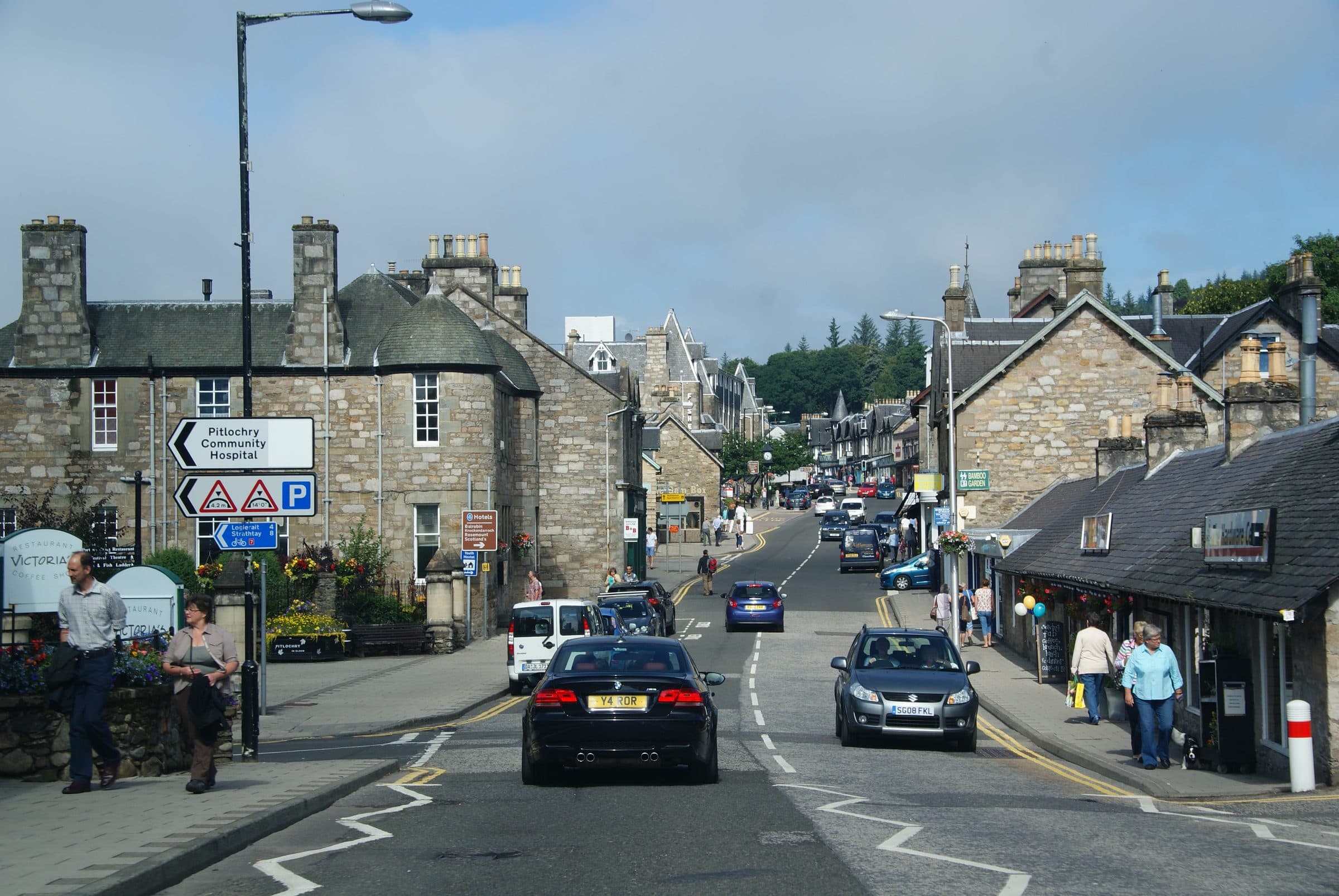 Atholl Road, the main street through Pitlochry, lined with grey stone buildings and shops.